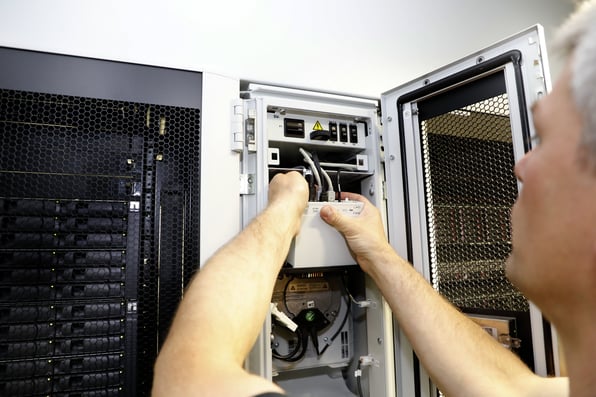 A data centre manager checking equipment that is ready for an upgrade. 